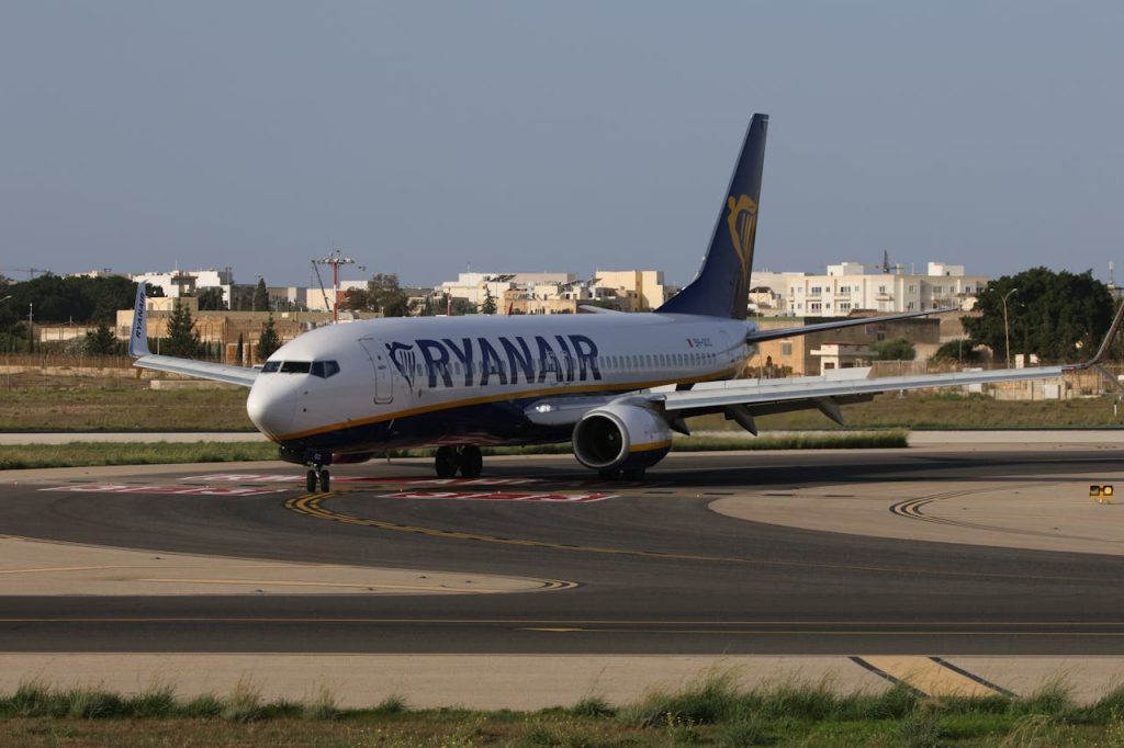 pexels-photo-28787084 Ryanair airplane taxiing on runway in sunny weather at an airport in daylight.